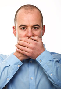 Close-up portrait of young man against white background