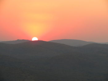 Scenic view of silhouette mountains against sky during sunset