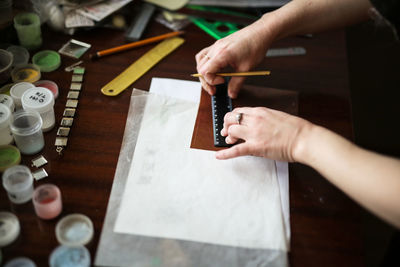 The master in the creative workshop is working on the product, enamel for metal, drawing. 