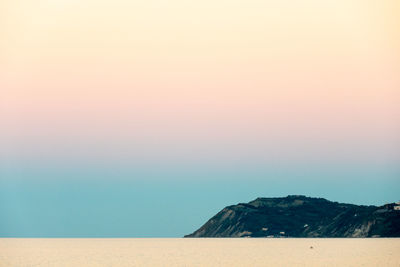 Scenic view of sea against clear sky during sunset