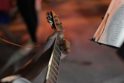 Cropped hand playing guitar