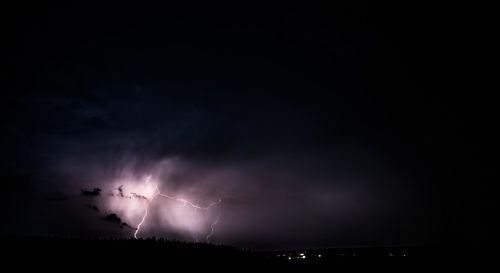 Low angle view of lightning against sky at night