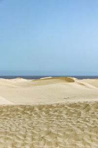 Scenic view of beach against clear sky