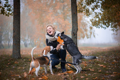 Full length of woman with dog on street