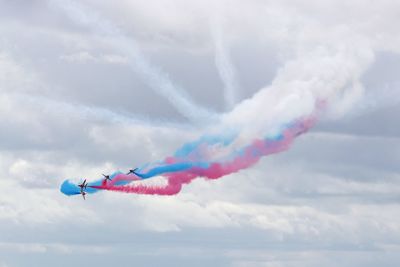 Low angle view of airshow against sky