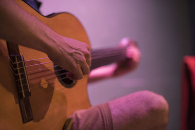 Close-up of hand playing guitar
