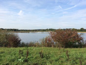 Scenic view of lake against cloudy sky