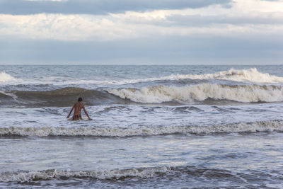 Man standing on beach against sky