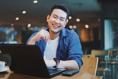 Young man using laptop at table