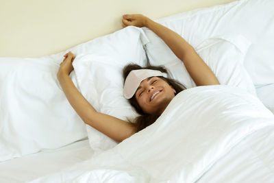 Woman waking up on bed at morning