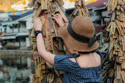 Rear view of woman standing at market stall