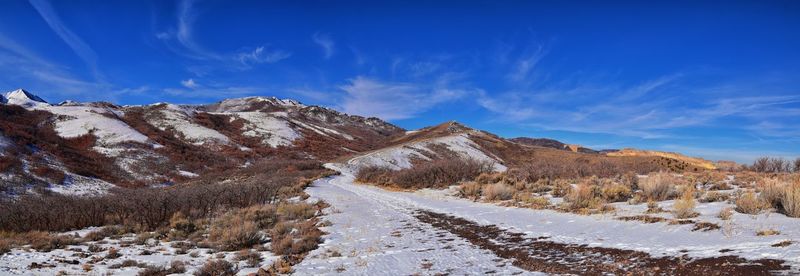 Scenic view of snowcapped mountain against blue sky