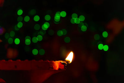 Close-up of illuminated diya at night