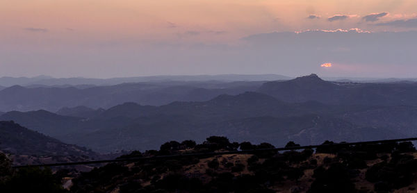 Scenic view of mountains against sky during sunset