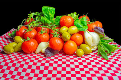 Close-up of fruits on table against black background