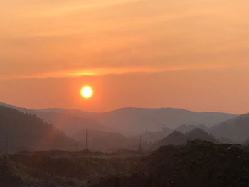 Scenic view of mountains against sky during sunset