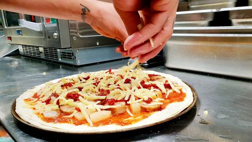 Midsection of person preparing food in kitchen