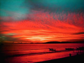 Scenic view of dramatic sky over sea during sunset