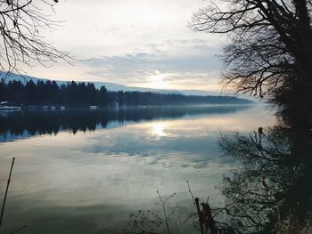 Scenic view of lake against sky at sunset