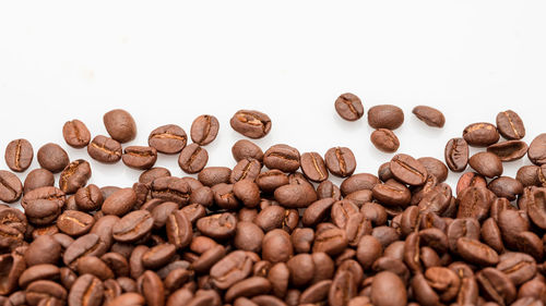 Close-up of coffee beans against white background
