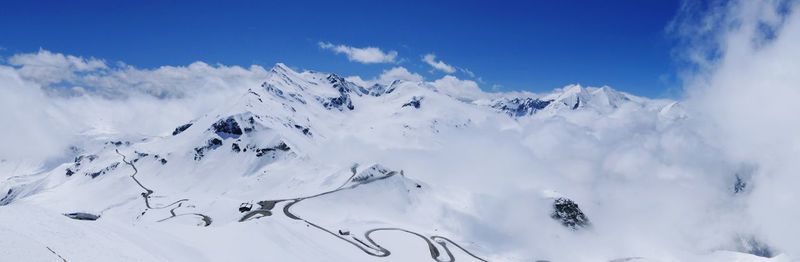 Low angle view of snowcapped mountains against sky