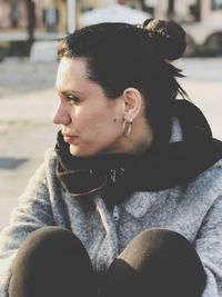 Close-up portrait of young woman looking away