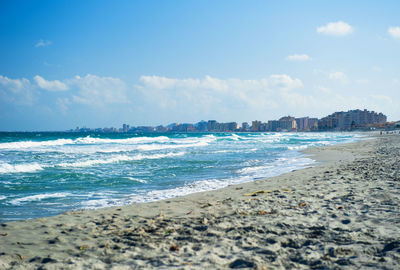 View of beach against cloudy sky