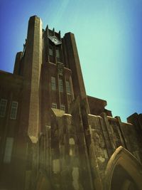 Low angle view of historic building against blue sky