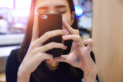 Close-up of woman using mobile phone