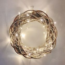 Close-up of illuminated light bulb hanging on ceiling