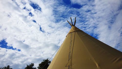 Low angle view of traditional windmill against sky