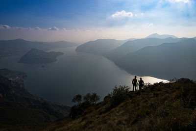 People on mountain against sky