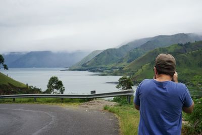 Man looking at lake