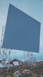 Low angle view of a panel on mountain against sky