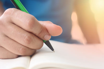 Close-up of hand holding book