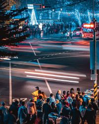 Crowd on city street at night