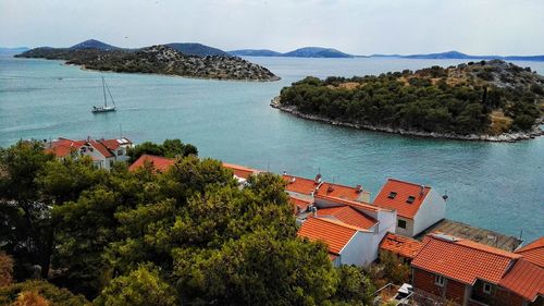 High angle view of trees by sea against sky