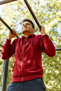 Sport man stretching at the park autumn, doing man do stretching exercises at autumn park. 