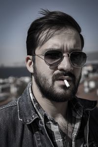Portrait of young man smoking cigarette