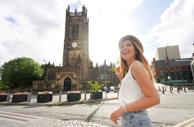 Portrait of gorgeous woman walking on sunny day in the city of manchester, uk