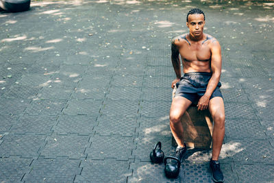 Portrait of young man sitting in city