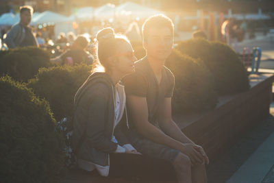 Young couple sitting outdoors