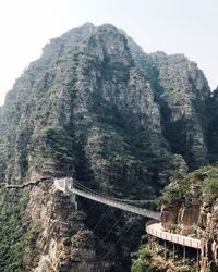 Low angle view of rocky mountains against sky