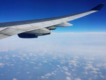 Airplane flying against blue sky