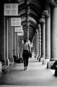 Rear view of woman walking in corridor