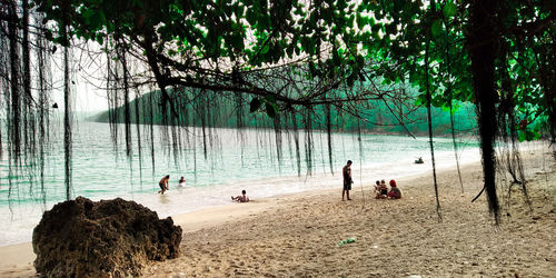 People on beach by sea