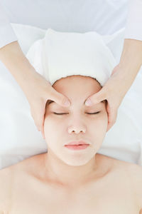 Portrait of shirtless man lying on bed