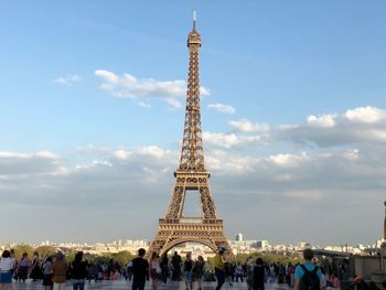 Group of people in city against sky