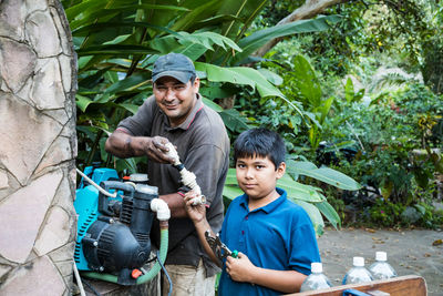 Portrait of father and son on plant