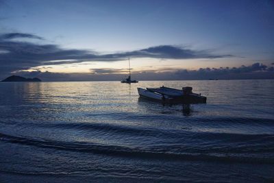 Boat moored on sea against sky